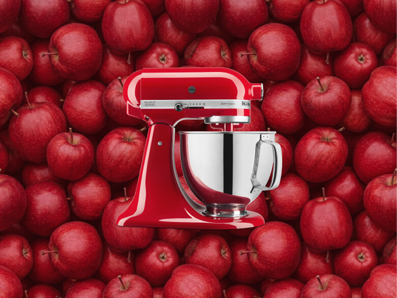 Red KitchenAid® stand mixer set against a background of apples