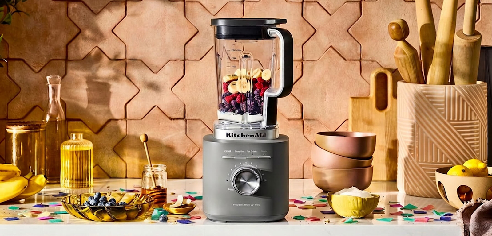 A KitchenAid® blender surrounded by ingredients and confetti