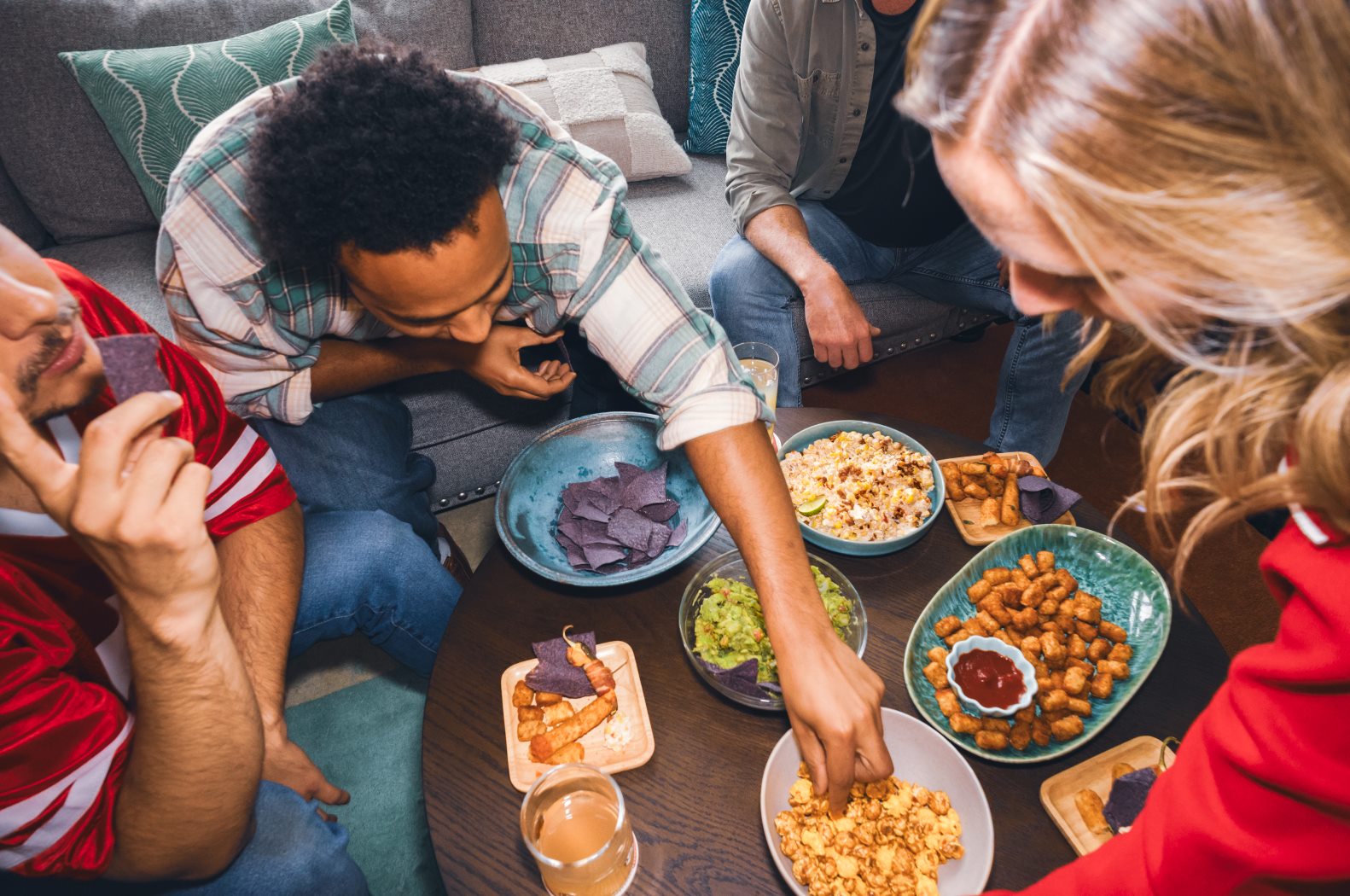 Friends Sharing Guacamole and Game Day Snacks
