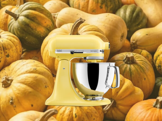 Yellow KitchenAid® stand mixer set against a background of gourds and pumpkins