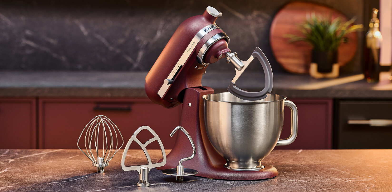 KitchenAid® Artisan Plus stand mixer with whisk and beater attachments on a counter