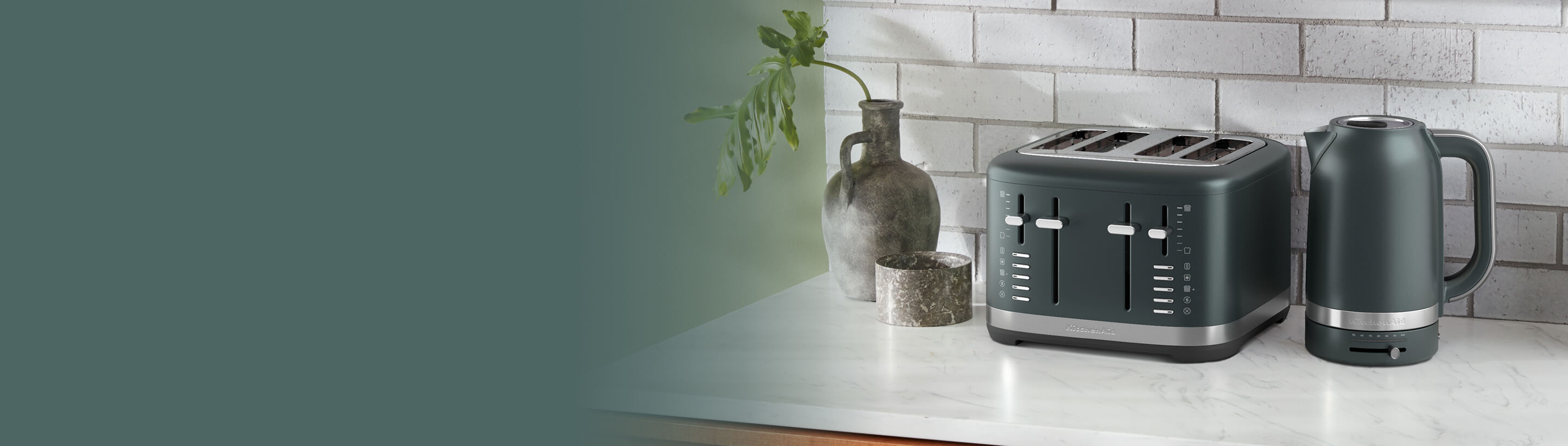 A green KitchenAd® toaster and kettle