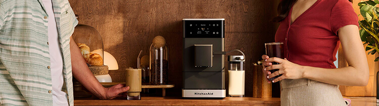 Two people standing next to a KitchenAid® Fully Auto Espresso with Ice
