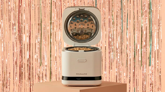 A KitchenAid® grain and rice cooker in front of a shiny decorative background
