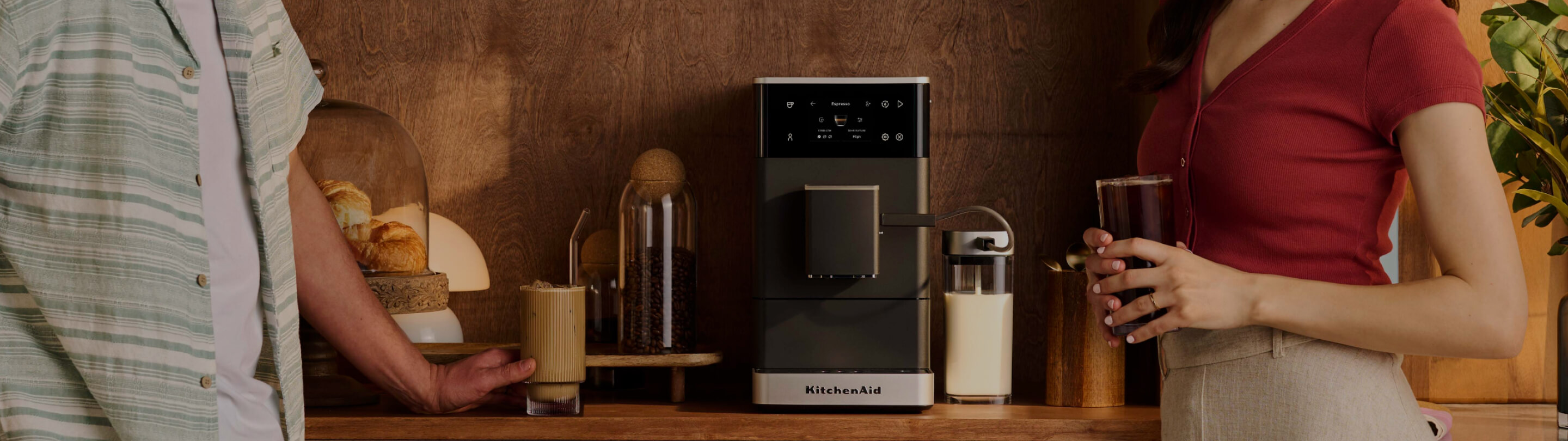 Two people standing next to a KitchenAid® Fully Auto Espresso with Ice
