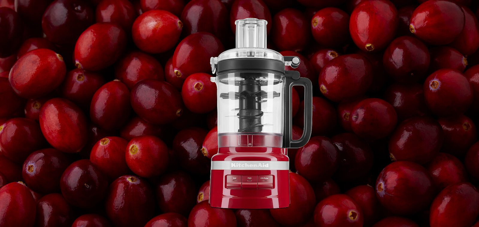 Red KitchenAid® food processor set against a background of cranberries
