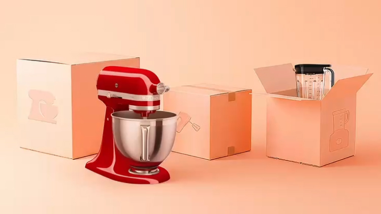 A video of confetti falling over a KitchenAid stand mixer, blender and unopened boxes.