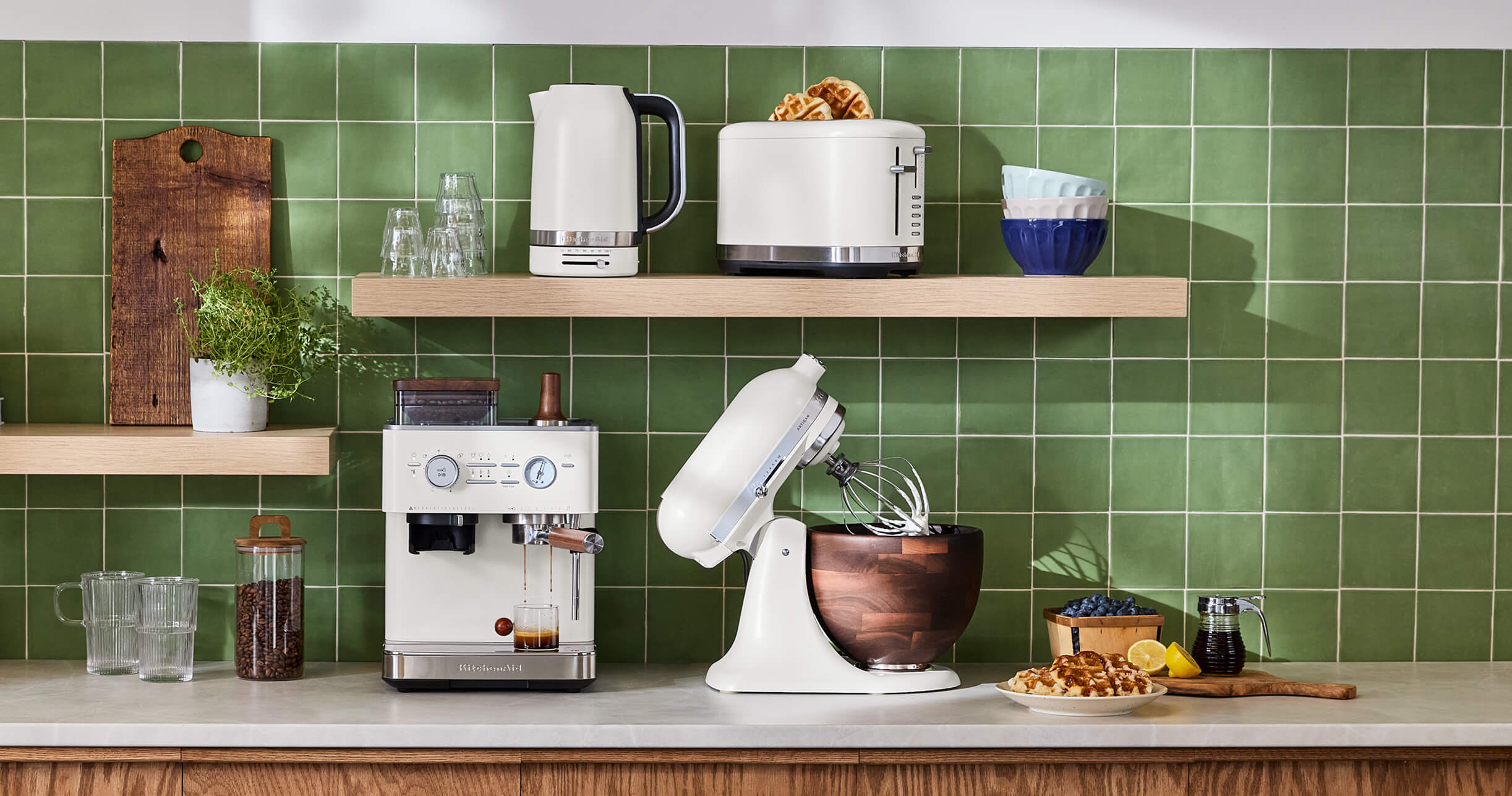 A collection of white KitchenAid® countertop appliances