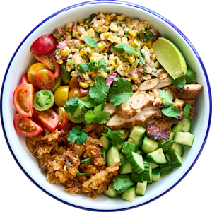 Elote Crispy Rice Salad topped with grilled corn, chicken, cherry tomatoes, cucumber, crispy rice, cilantro, and a lime wedge