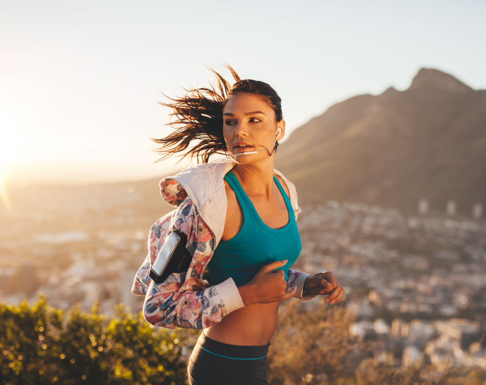 young-woman-running-with-city-and-mountain-in-the-background-i-screen