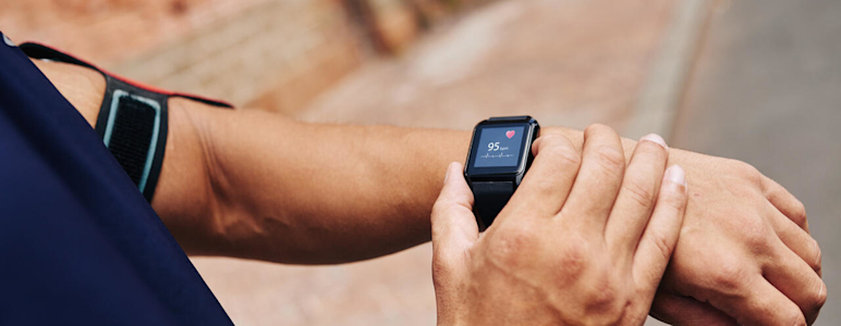 Mann misst seinen Puls mit einer Smartwatch.