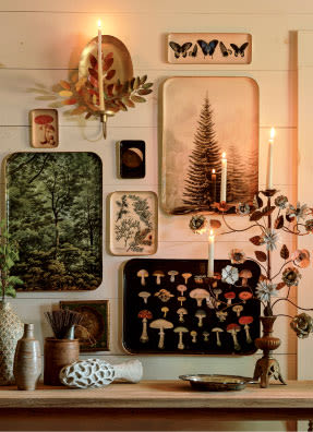 Trays on wall with candles on mantel