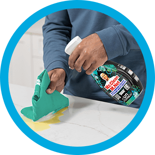 A person cleaning a kitchen countertop with CleanFreak Unstopables