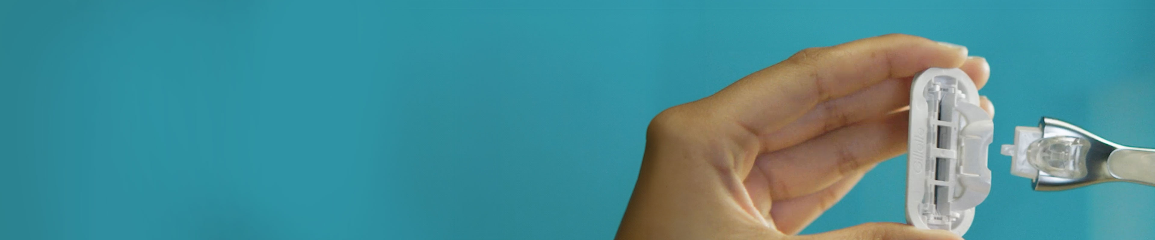 Femme tenant une recharge de lame Venus et la fixant sur un manche de rasoir