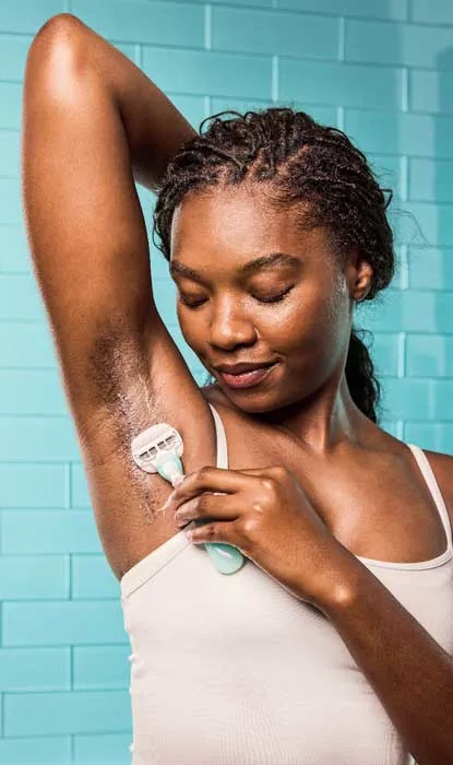 Woman shaving her leg with Gillette Venus razor in the bathroom