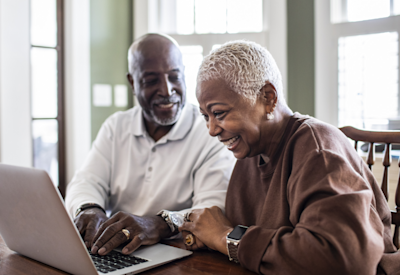 Smiling senior couple on laptop