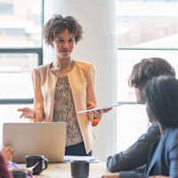 Woman speaking to a group of people in an office