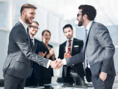 Advisors shake hands after reaching an agreement to buy an advisory practice