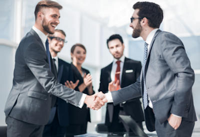 Advisors shake hands after reaching an agreement to buy an advisory practice