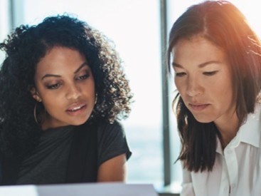 two women review financing options for their advisory business