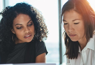 two women review financing options for their advisory business