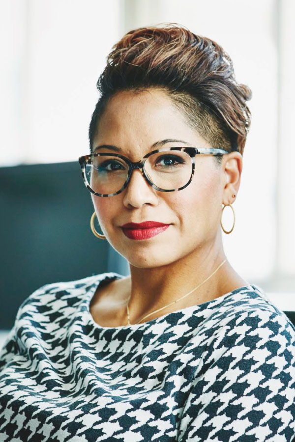 Confident business woman sitting in chair making eye contact