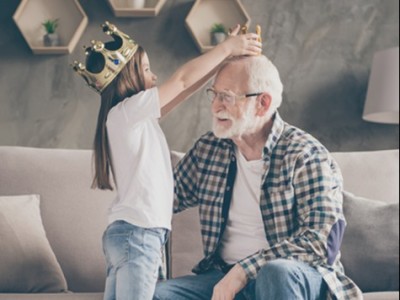 a senior client plays with his granddaughter