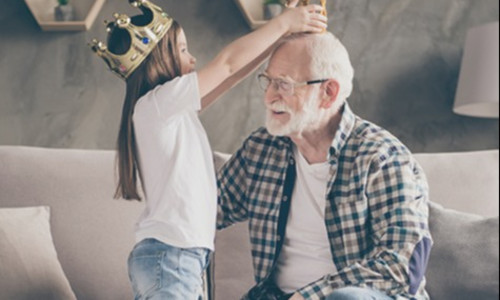 a senior client plays with his granddaughter