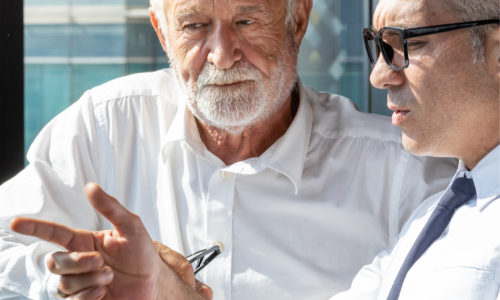 two businessmen discussing the sunset of the TCJA