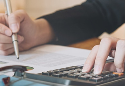 a businesswoman reviewing financial information on a spreadsheet