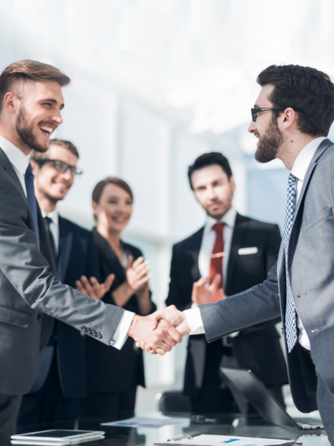 Advisors shake hands after reaching an agreement to buy an advisory practice