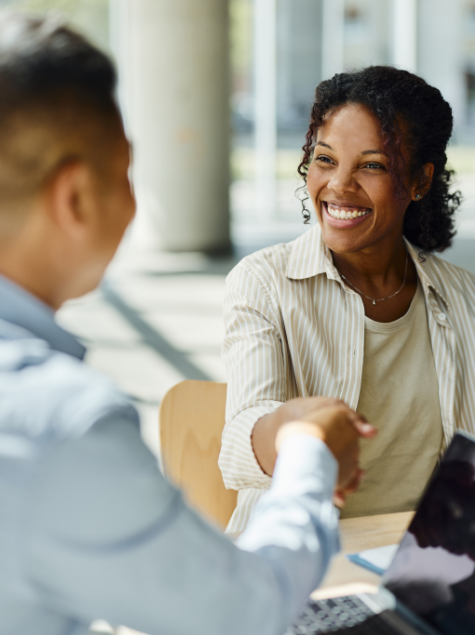 Smiling woman shaking hand with man