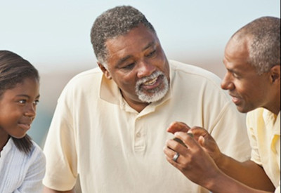 a Black family spanning three generations engaged in conversation