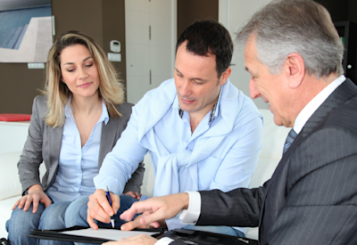 An advisor meets with his two high-net-worth clients