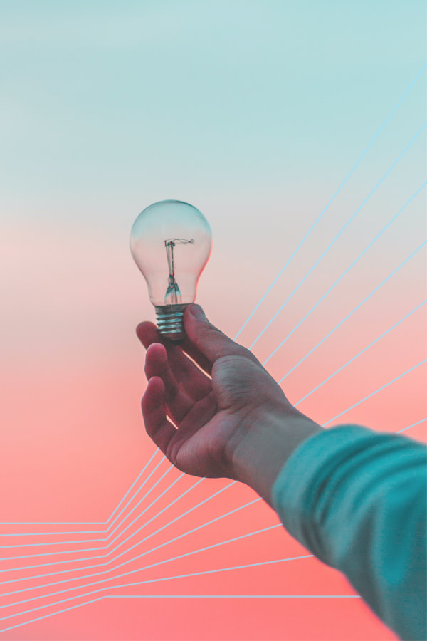 hand holding light bulb