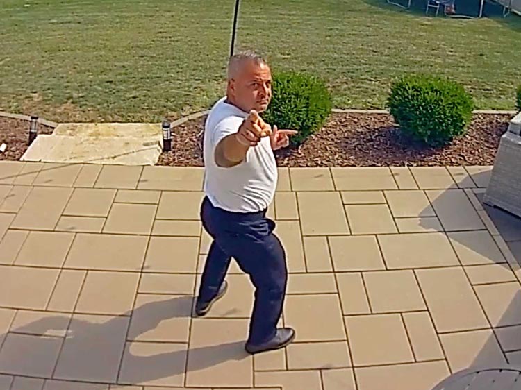 Man dances and points to the camera.