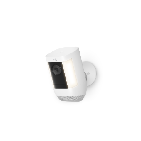 A white Ring Spotlight Cam Pro Battery is mounted on a wall, featuring a security camera with built-in LED lights.