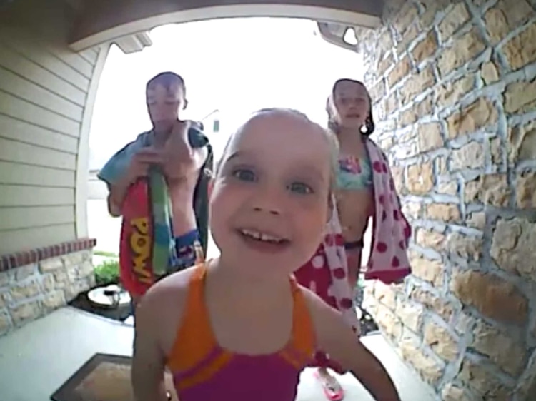Kids putting their face up close to a camera.