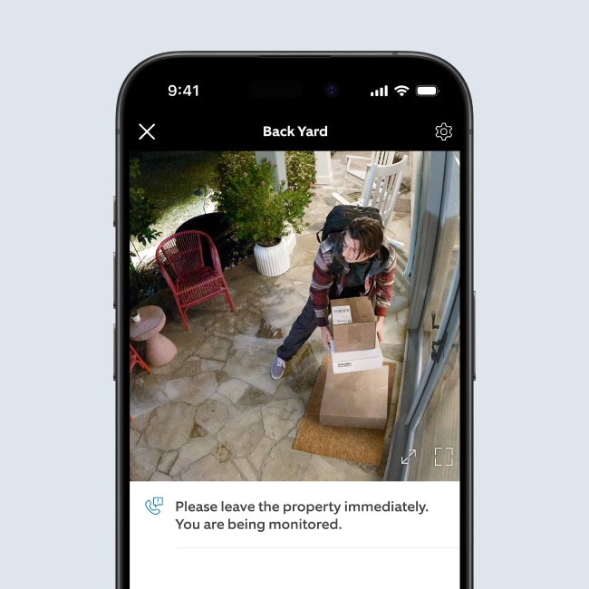 Security footage of a person taking packages from a residence. The Quick Reply option reads Please leave the property immediately. You are being monitored.