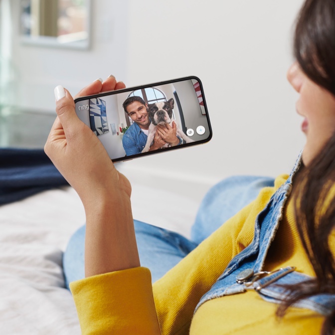 woman looking at man and dog on phone