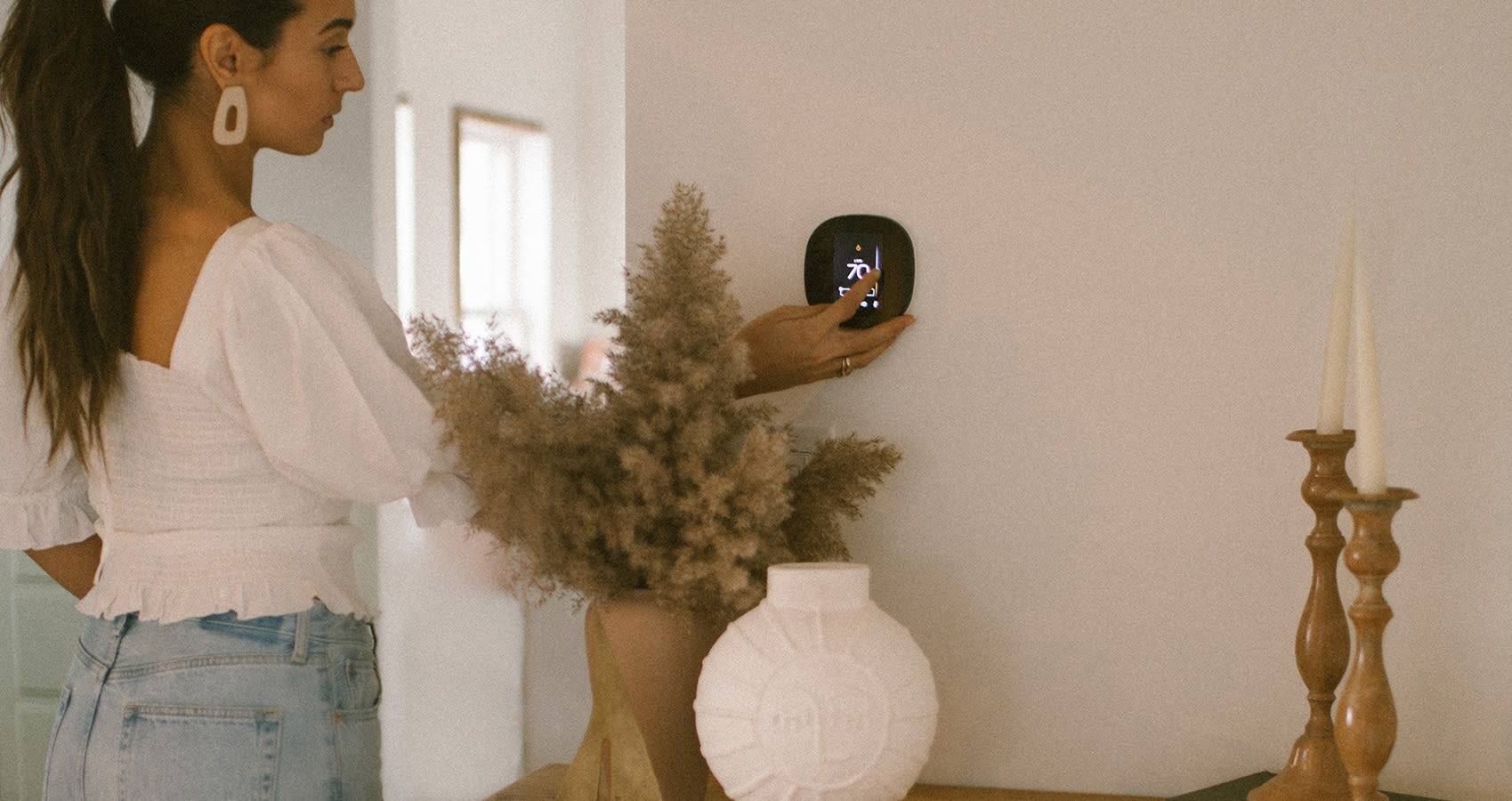 Elana controlling the temperature using the ecobee SmartThermostat slider.