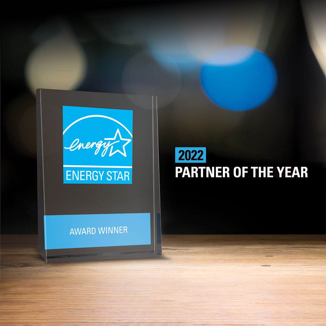 A glass plaque award next to a graphic saying "2022 Partner of the Year"