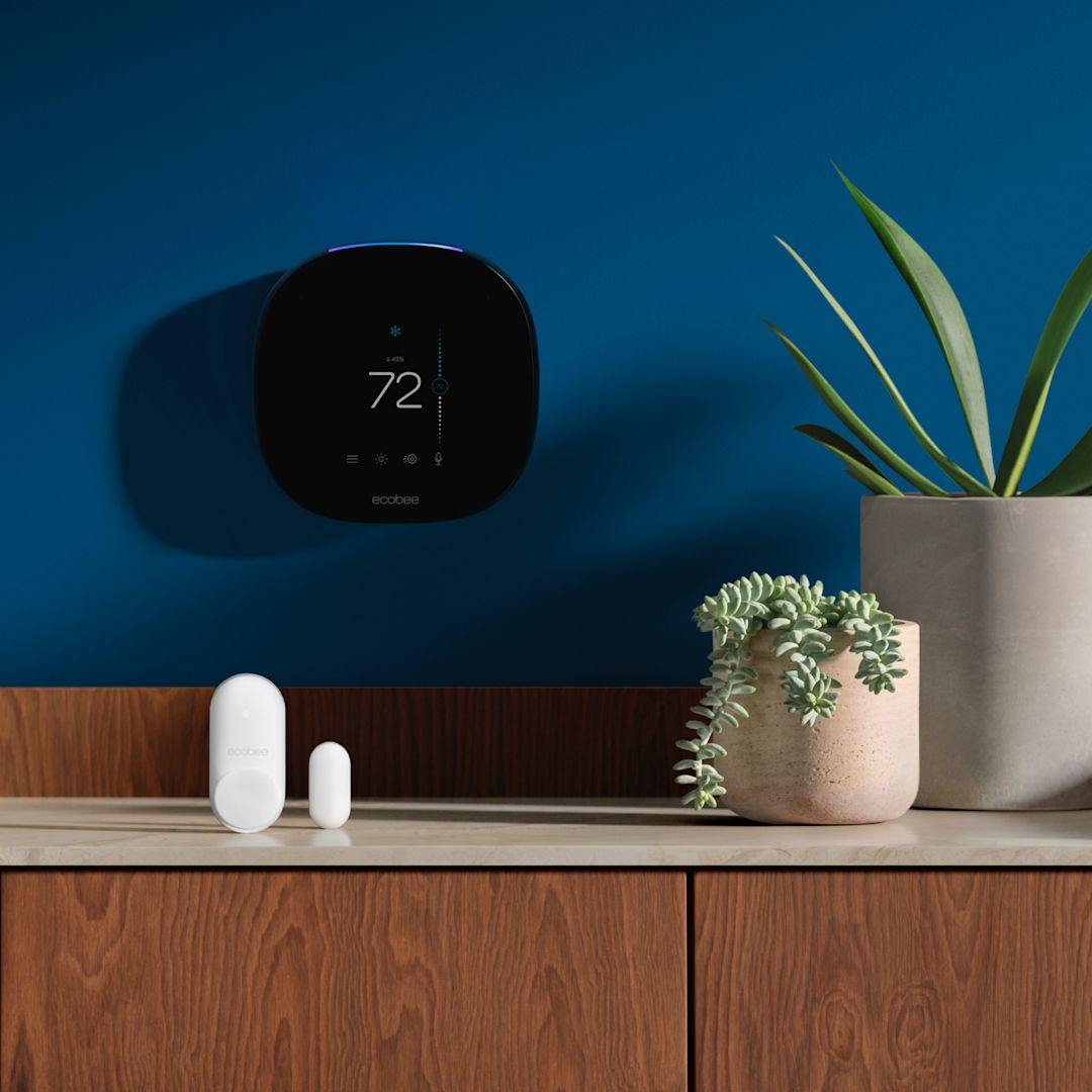 An ecobee thermostat and SmartSensors on a blue background