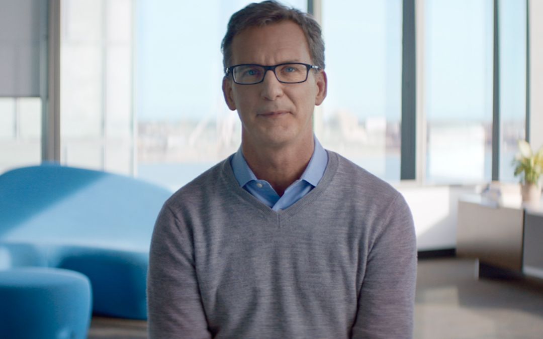 ecobee's visionary Founder and CEO Stuart Lombard poses for a photograph in the company's offices on Toronto's lakefront (pictured in background).