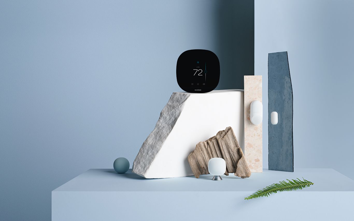 Smart Thermostat with Whole Home Sensors on a blue background