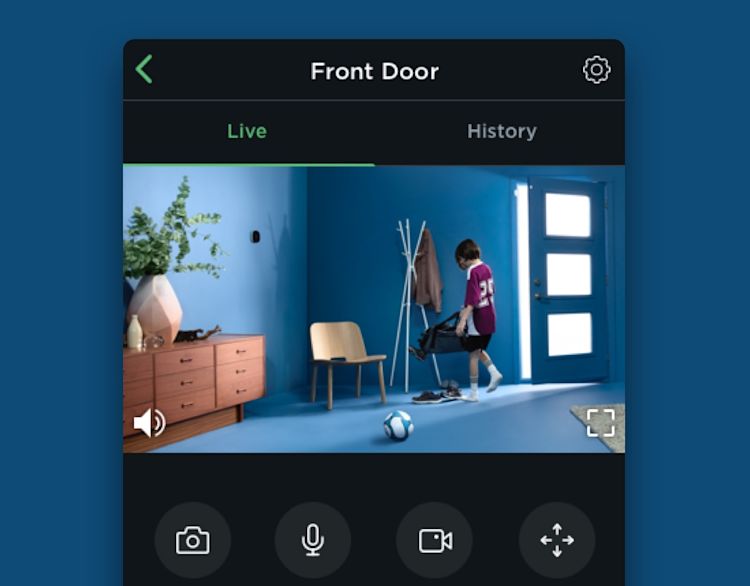 home monitoring cell phone screen camera view of child at doorway.