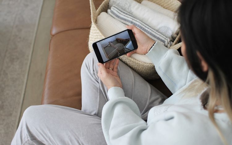 A woman watches her baby sleep through the ecobee app.
