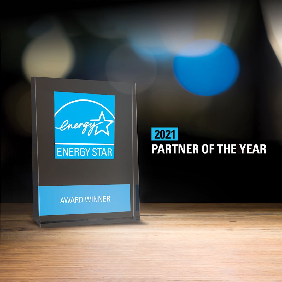 A glass plaque award next to a graphic saying "2021 Partner of the Year"