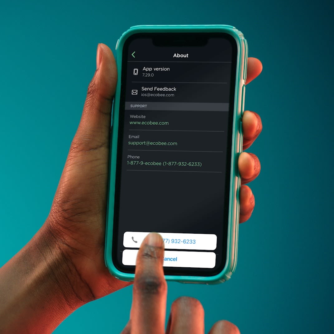 ecobee user holding smartphone calls customer care from the ecobee app.