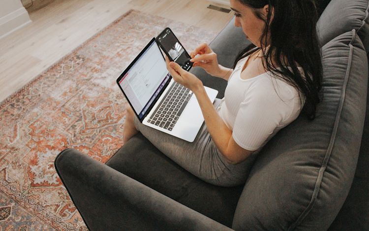 A woman looks at the ecobee app on her phone.